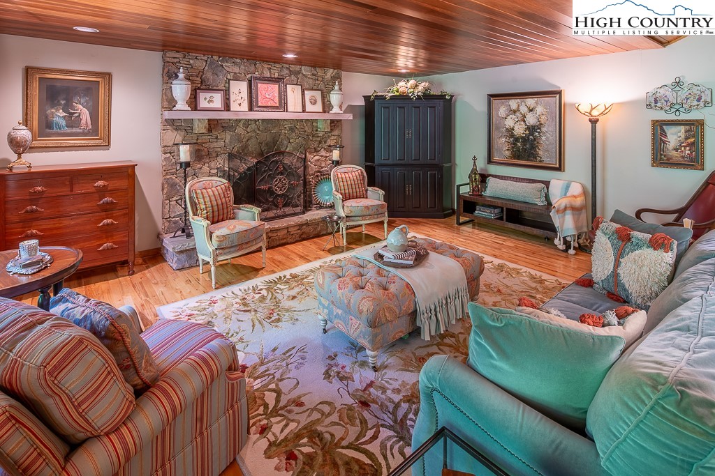 127 Apple Tree Boone, NC 28607 - Photo 14 of 50 a bedroom with furniture and a fireplace