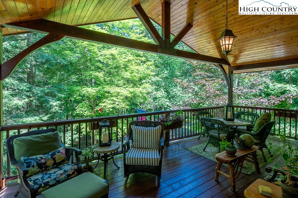 127 Apple Tree Boone, NC 28607 - Photo 23 of 50 a view of a balcony with chairs and wooden floor