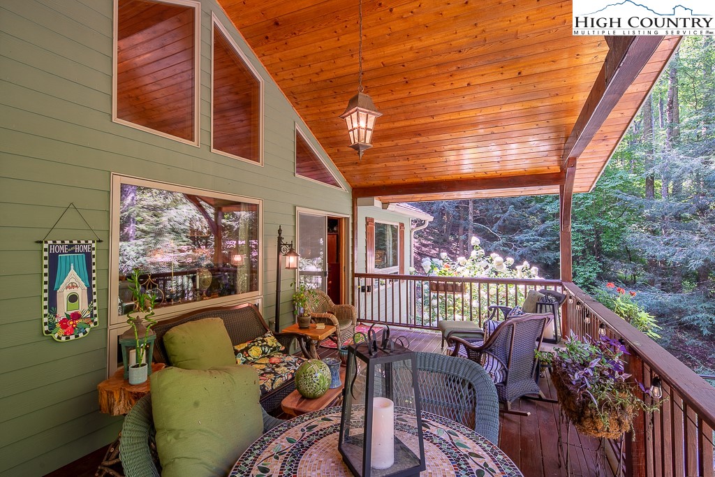 127 Apple Tree Boone, NC 28607 - Photo 25 of 50 a view of a patio with couches chairs and wooden floor