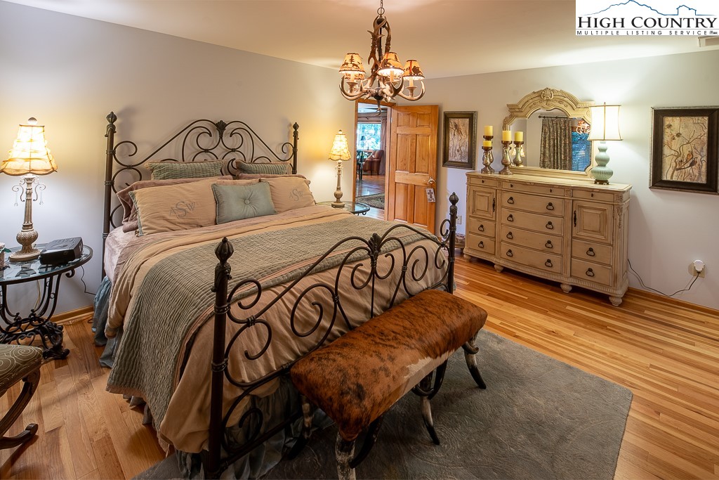 127 Apple Tree Boone, NC 28607 - Photo 28 of 50 a bedroom with a bed and wooden floor