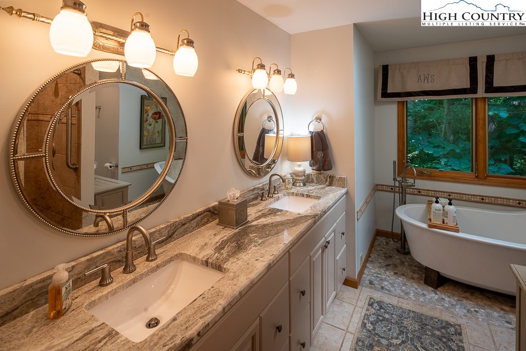 127 Apple Tree Boone, NC 28607 - Photo 29 of 50 a bathroom with a granite countertop double vanity sink and a mirror