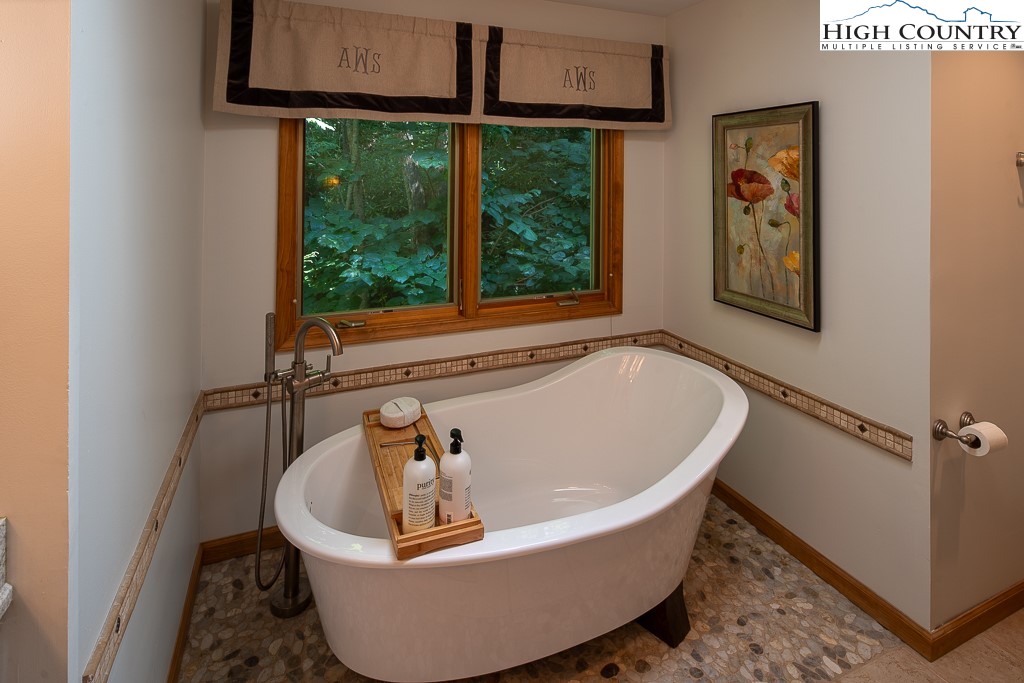 127 Apple Tree Boone, NC 28607 - Photo 30 of 50 a white bath tub sitting in a bathroom