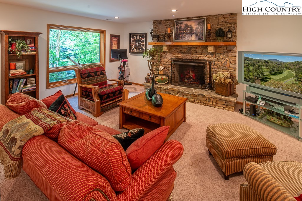 127 Apple Tree Boone, NC 28607 - Photo 33 of 50 a living room with furniture a floor to ceiling window and a fireplace
