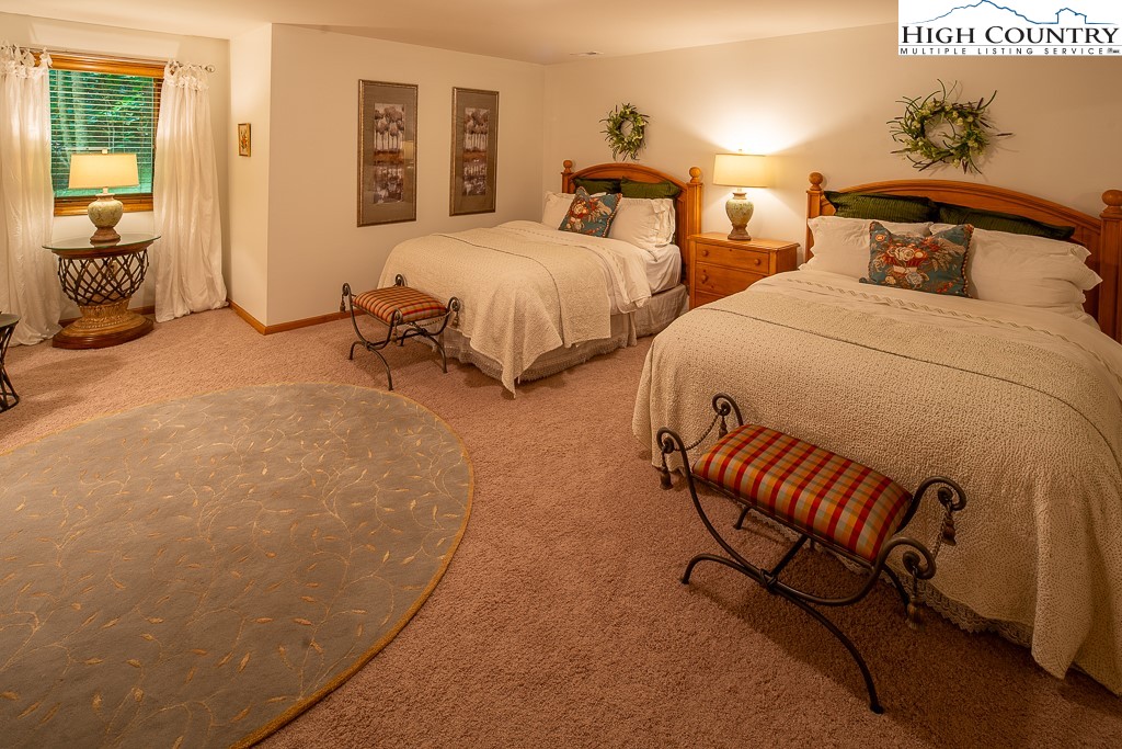 127 Apple Tree Boone, NC 28607 - Photo 36 of 50 a spacious bedroom with two beds and a couch