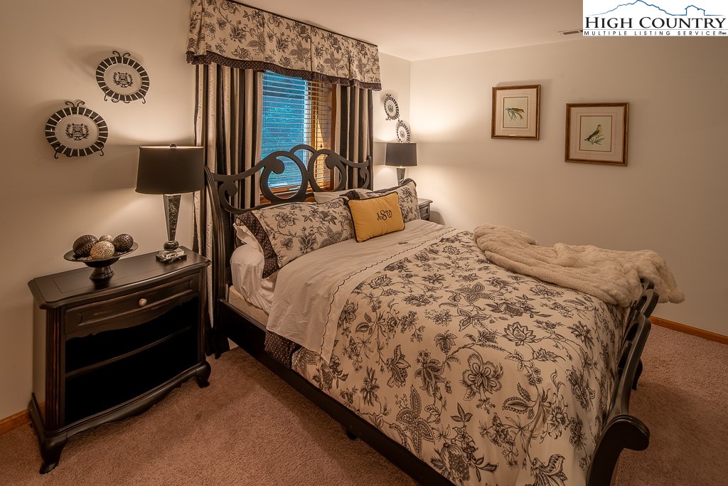 127 Apple Tree Boone, NC 28607 - Photo 39 of 50 a bedroom with a bed and wall painting