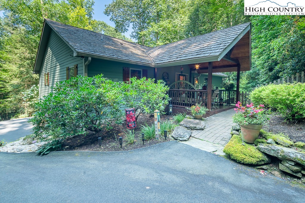 127 Apple Tree Boone, NC 28607 - Photo 4 of 50 a view of a chair and table in backyard of house