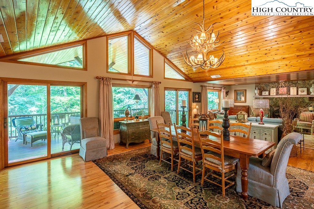 127 Apple Tree Boone, NC 28607 - Photo 8 of 50 a dining room with furniture a chandelier and wooden floor