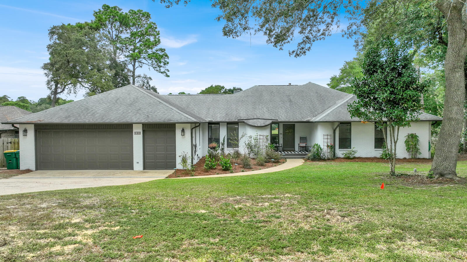 a front view of a house with a yard garage and outdoor seating