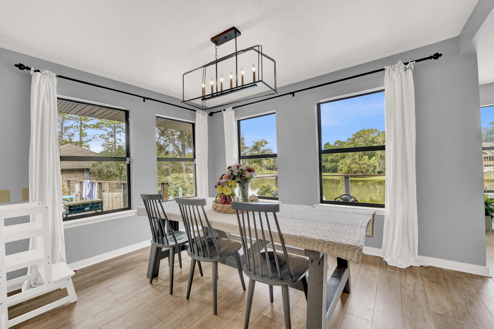 340 Ruckel Drive Niceville, FL 32578 - Photo 13 of 66 a view of a dining room with furniture a chandelier and wooden floor