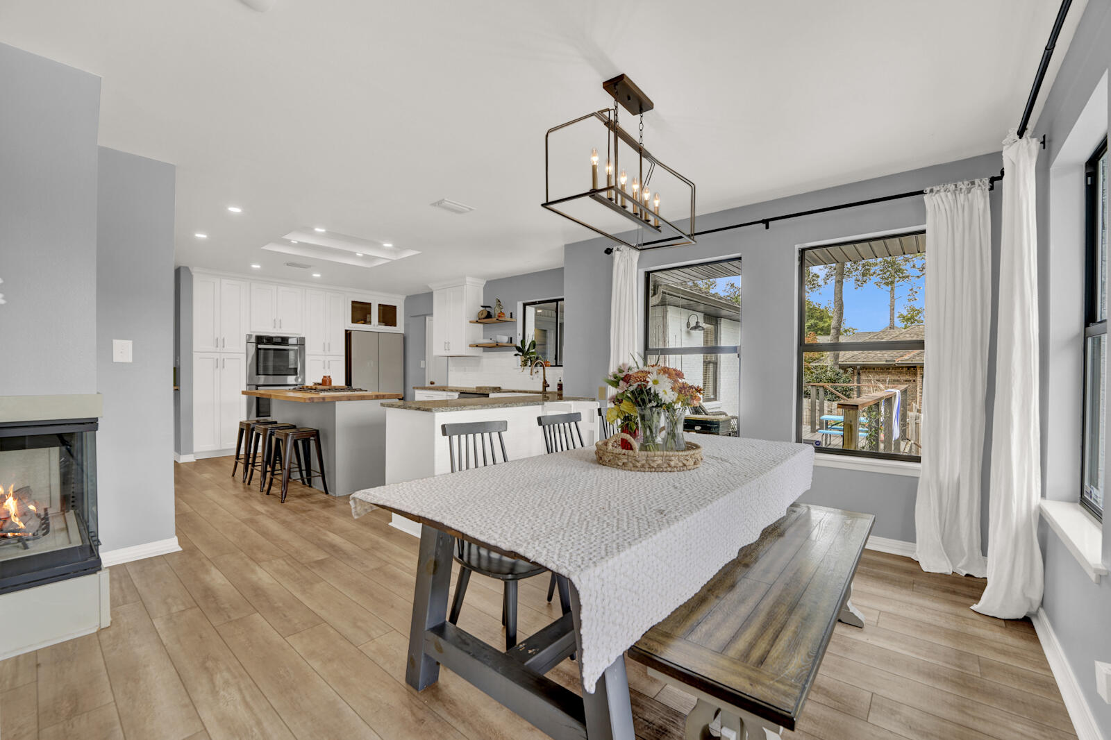 340 Ruckel Drive Niceville, FL 32578 - Photo 14 of 66 a view of a dining room and livingroom with furniture wooden floor a chandelier