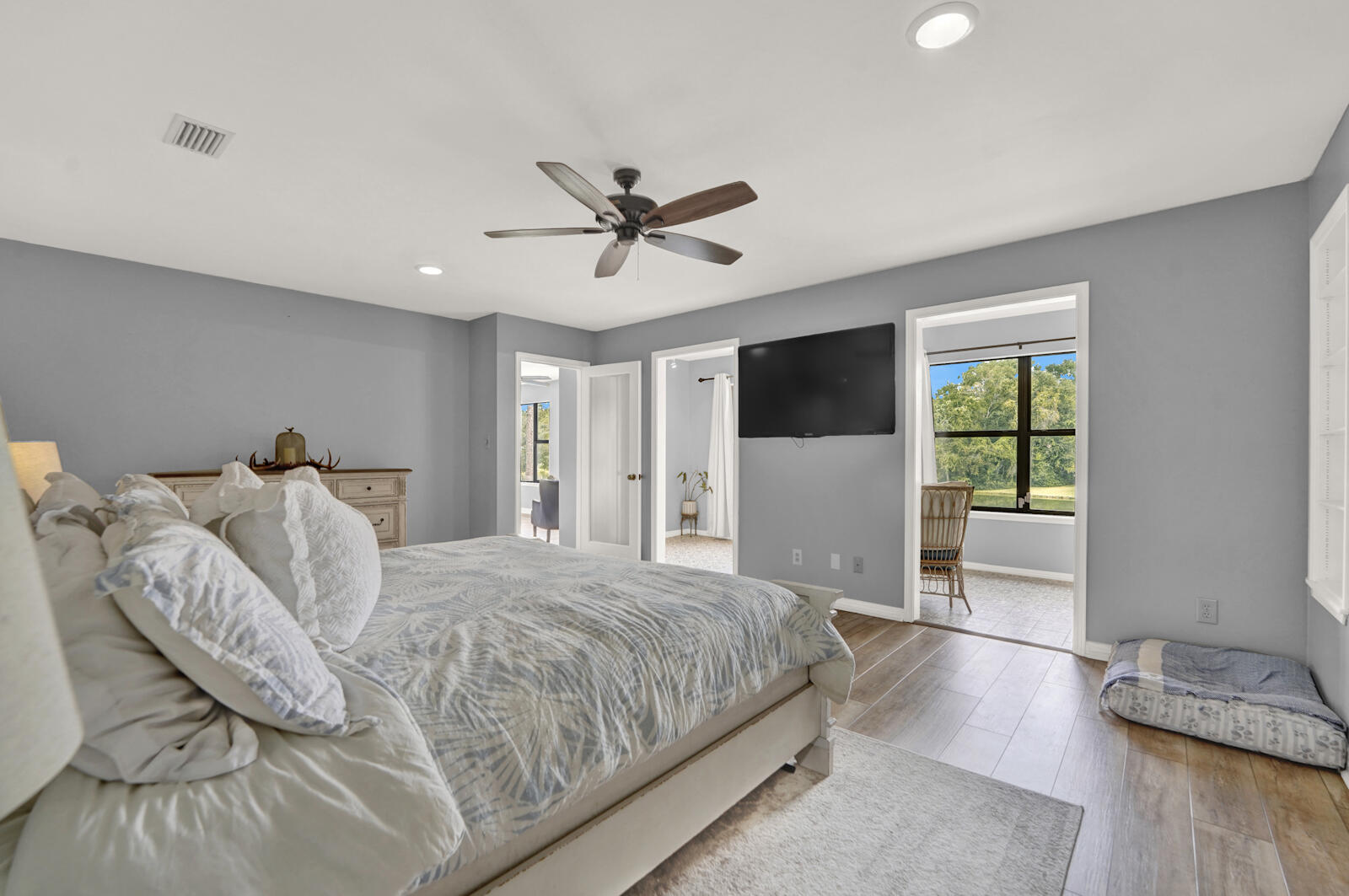 340 Ruckel Drive Niceville, FL 32578 - Photo 20 of 66 a bedroom with a large bed and a flat tv screen on dresser