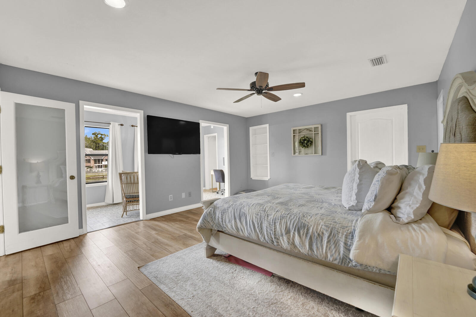 340 Ruckel Drive Niceville, FL 32578 - Photo 22 of 66 a bedroom with a large bed a flat tv screen and a closet