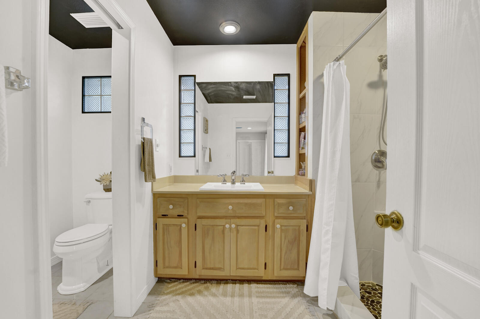 340 Ruckel Drive Niceville, FL 32578 - Photo 34 of 66 a bathroom with a granite countertop sink a toilet and shower