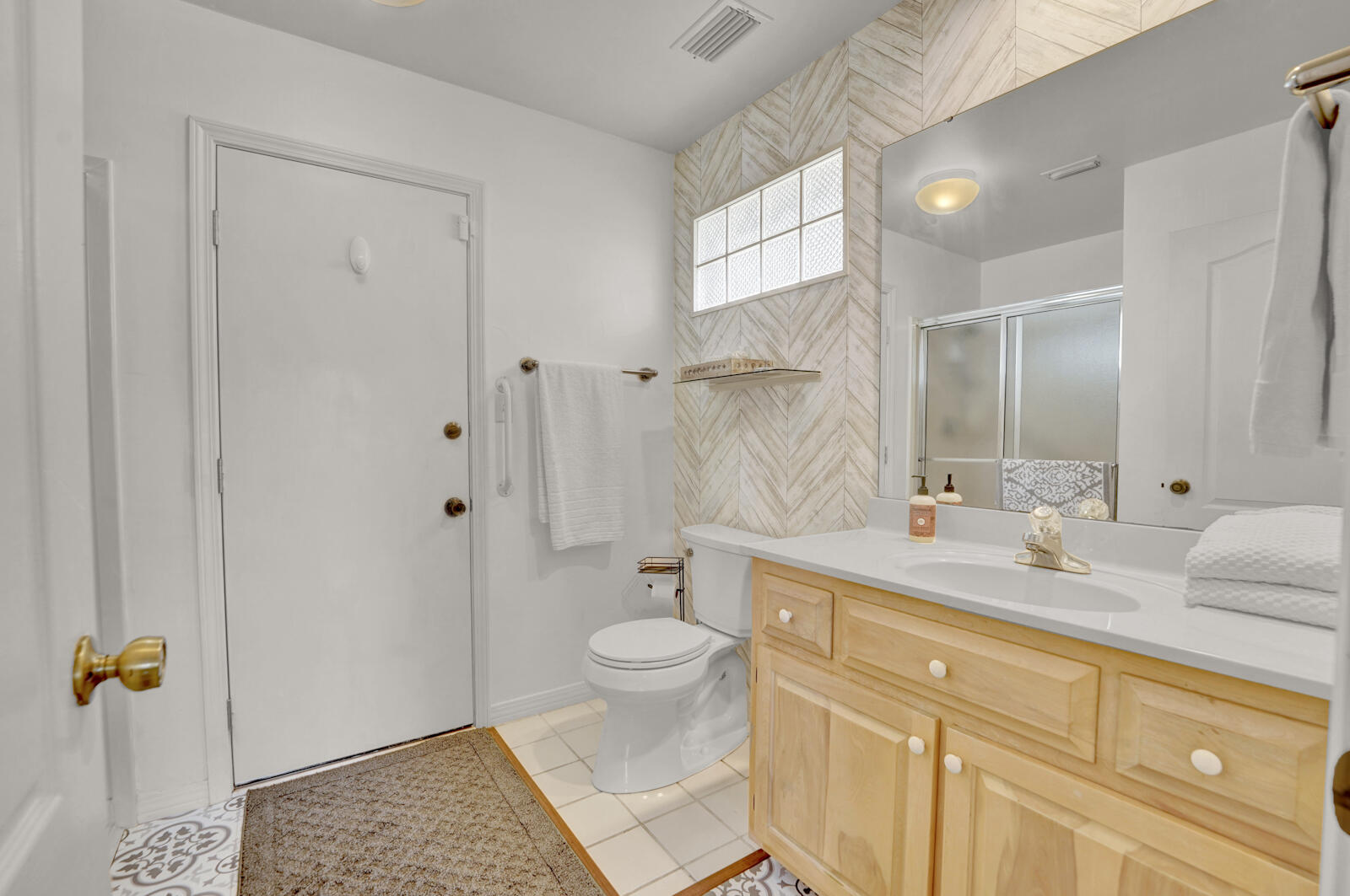 340 Ruckel Drive Niceville, FL 32578 - Photo 39 of 66 a spacious bathroom with a granite countertop sink a toilet a mirror and shower