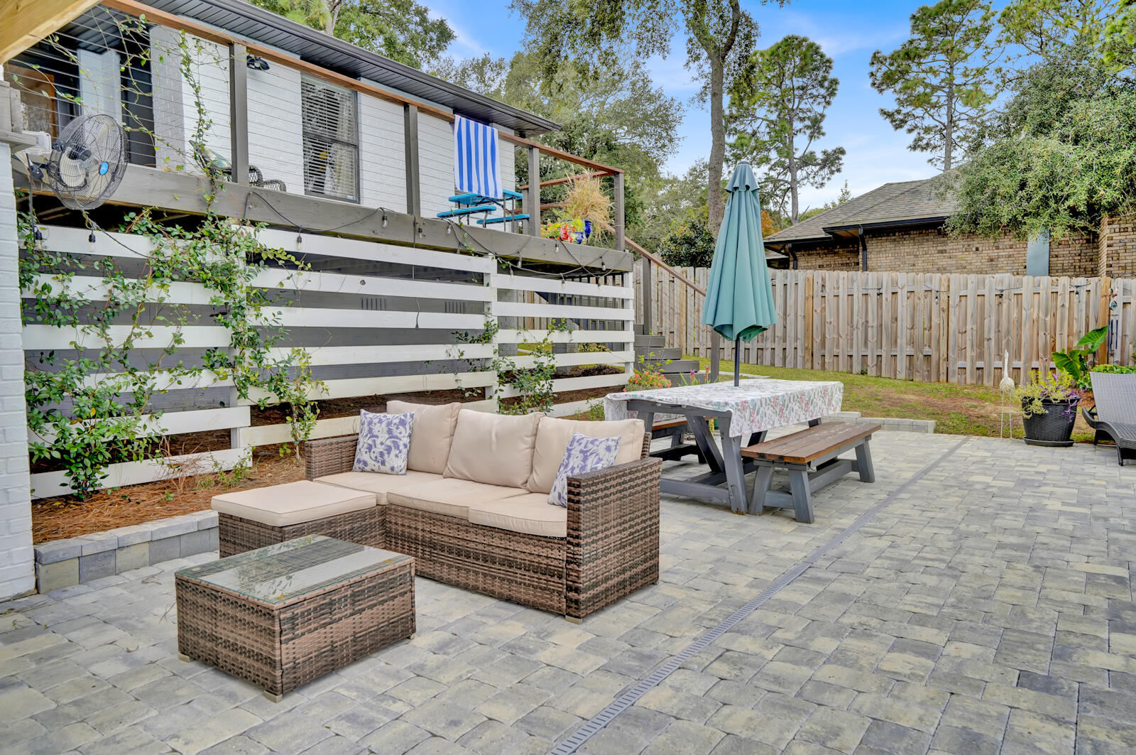340 Ruckel Drive Niceville, FL 32578 - Photo 56 of 66 a view of a patio with couches and a table and chairs with wooden fence