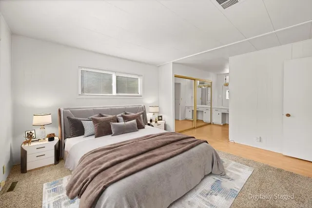 a spacious bathroom with a granite countertop sink and a mirror