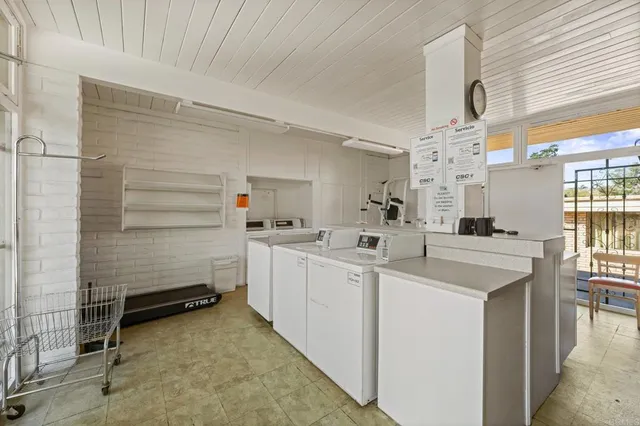 a view of a livingroom with furniture and a ceiling fan