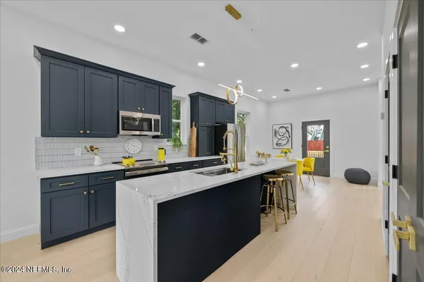 a kitchen with stainless steel appliances a sink counter space cabinets and a sink