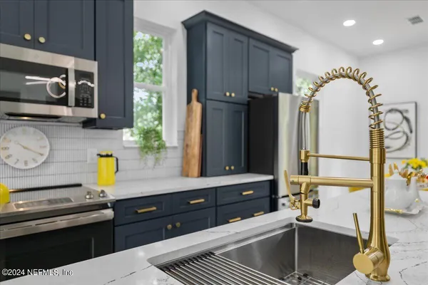 a kitchen with sink and cabinets