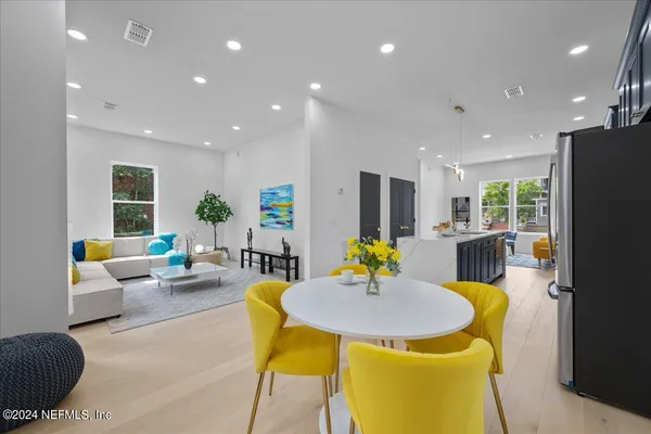 a living room with dining table furniture and kitchen view