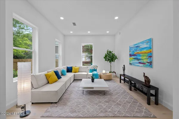 a living room with furniture and painting on the wall