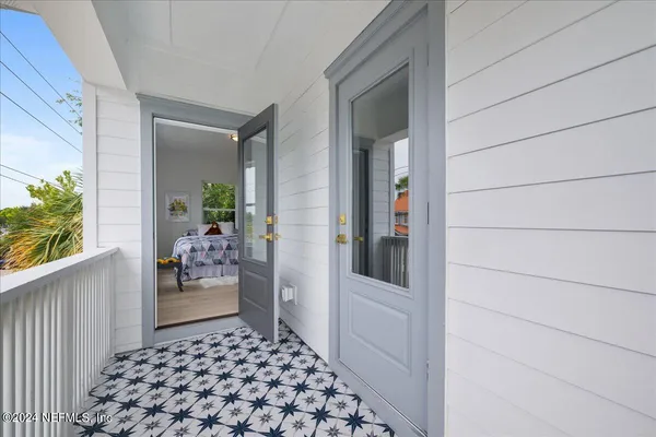 a view of a porch with wooden floor and plants