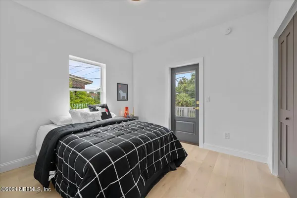 a bedroom with a bed and window