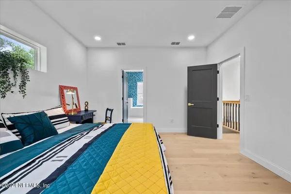 a bed room with a bed and a large window