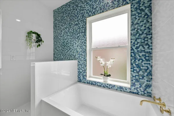 view of a bathroom with a bathtub and a sink