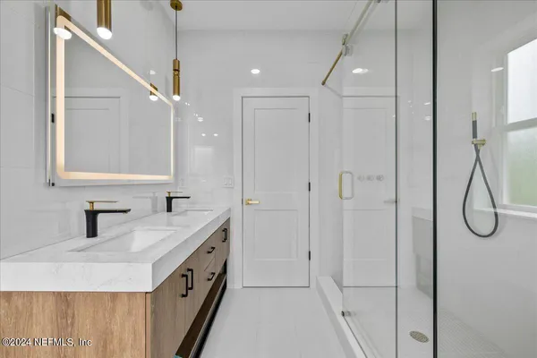 a bathroom with a double vanity sink mirror and double