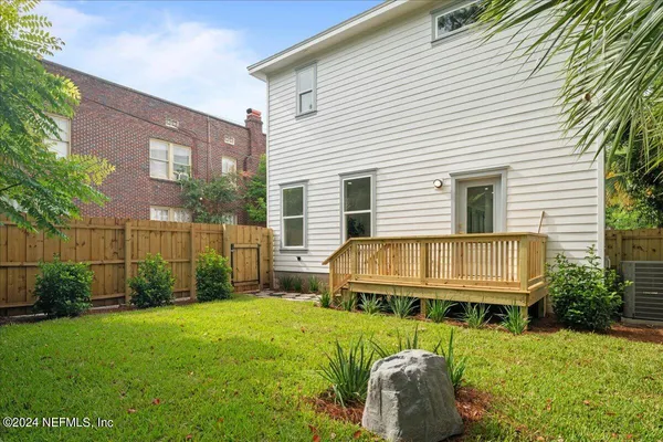 a backyard of a house with table and chairs