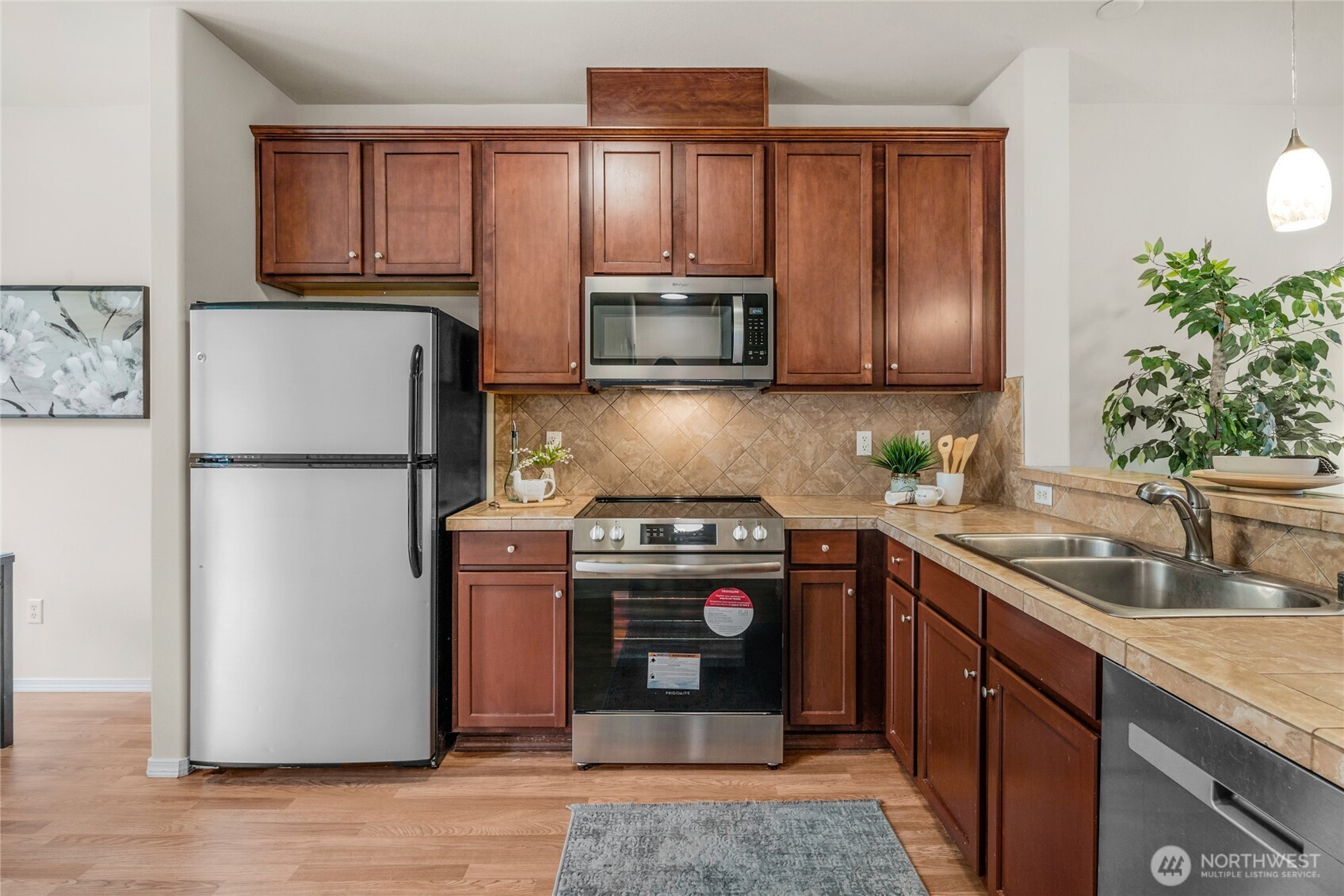 14915 38th Drive Southeast, Unit JJ1180 Bothell, WA 98012 - Photo 13 of 38 a kitchen with a refrigerator sink and microwave