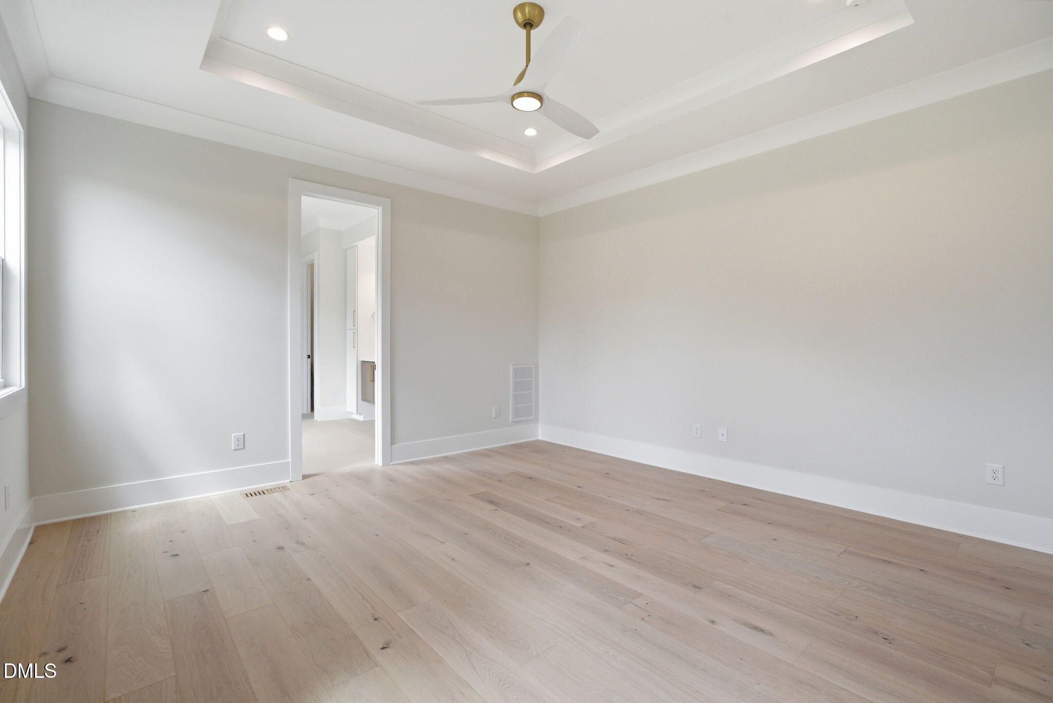 1304 Sanctuary Pond Drive Raleigh, NC 27606 - Photo 18 of 52 a view of an empty room with wooden floor