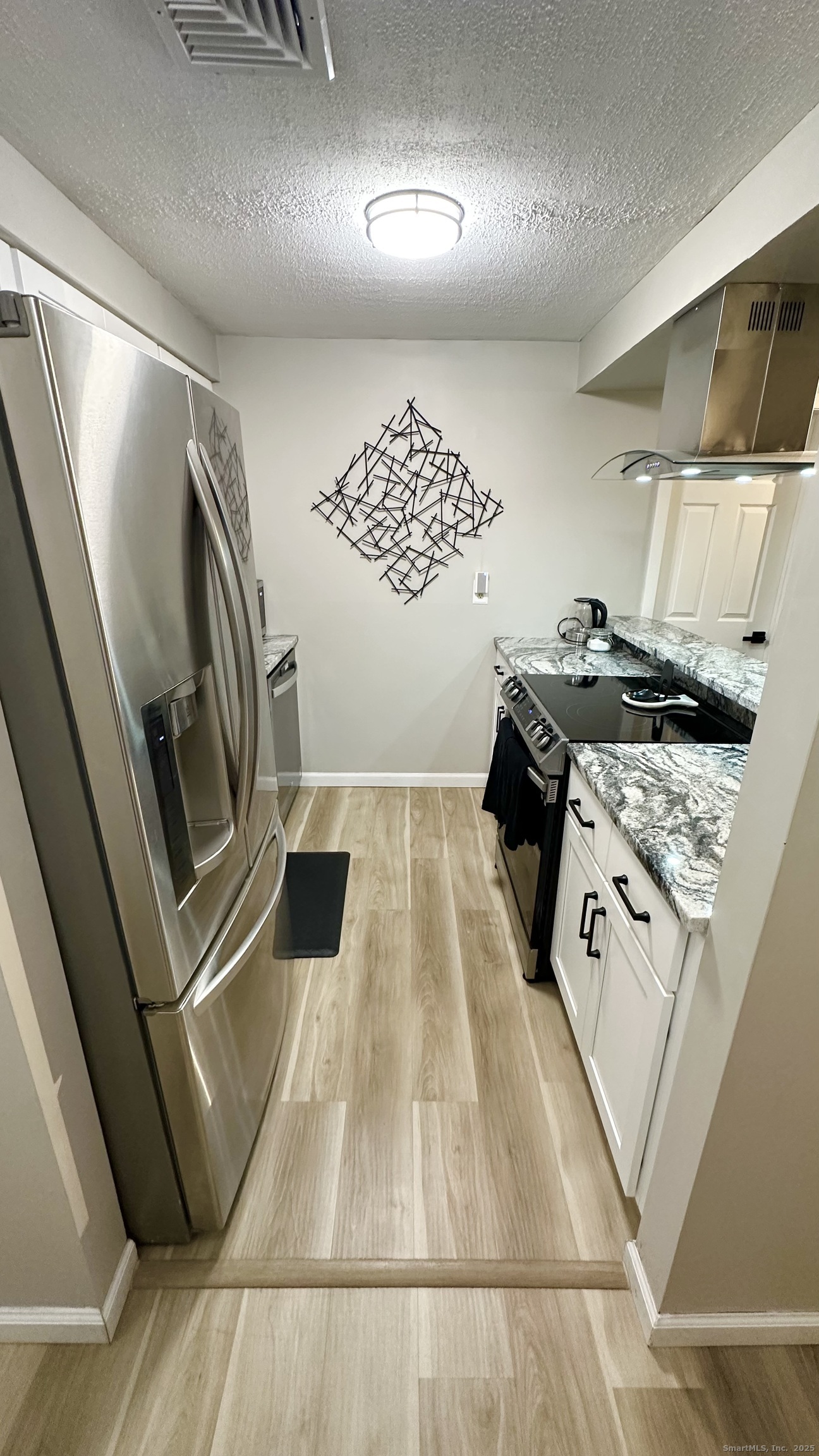 105 Tremont Avenue, Unit B Bridgeport, CT 06606 - Photo 11 of 24 a view of an empty room and wooden floor