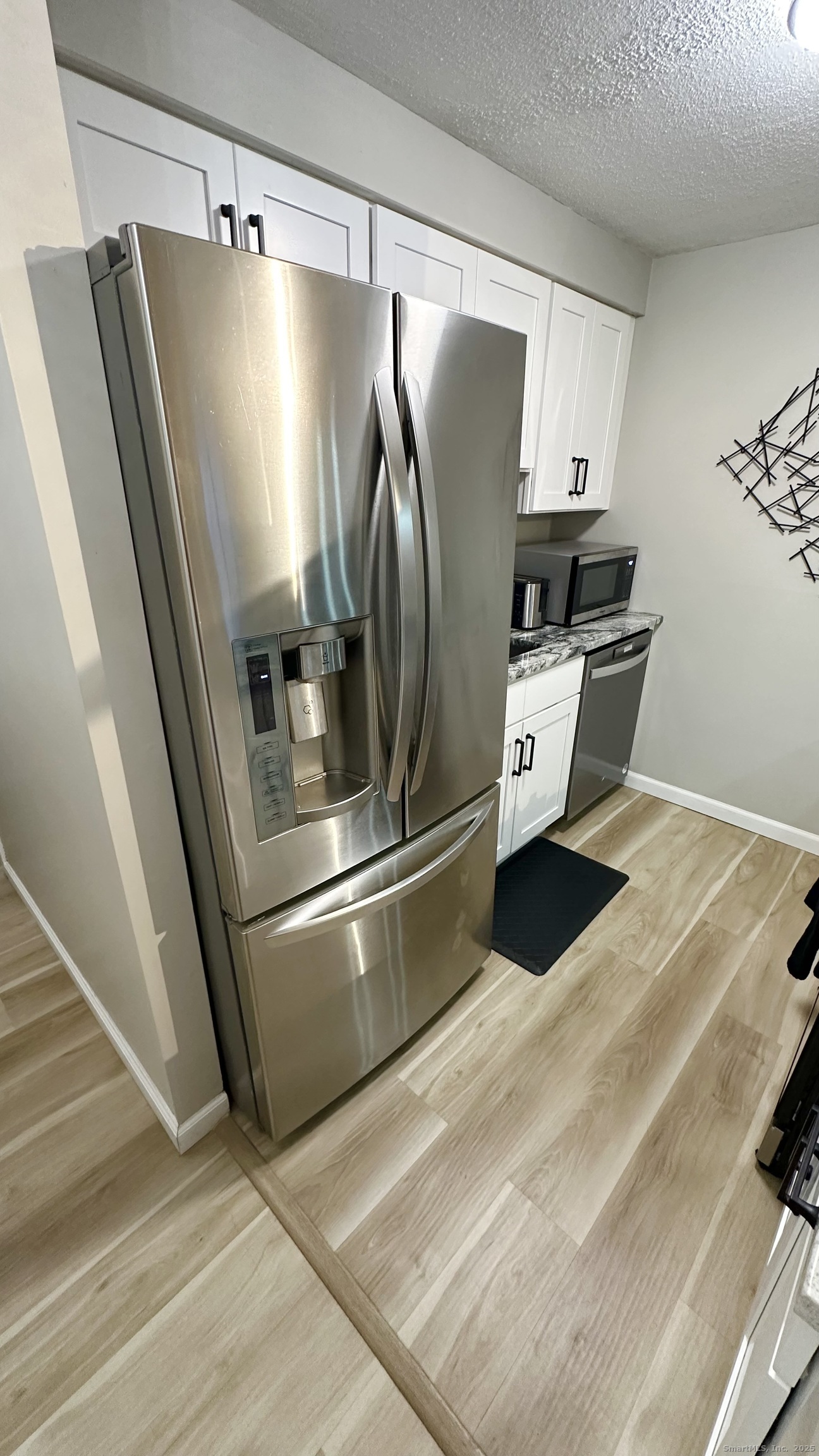 105 Tremont Avenue, Unit B Bridgeport, CT 06606 - Photo 13 of 24 a kitchen with stainless steel appliances a refrigerator and a stove