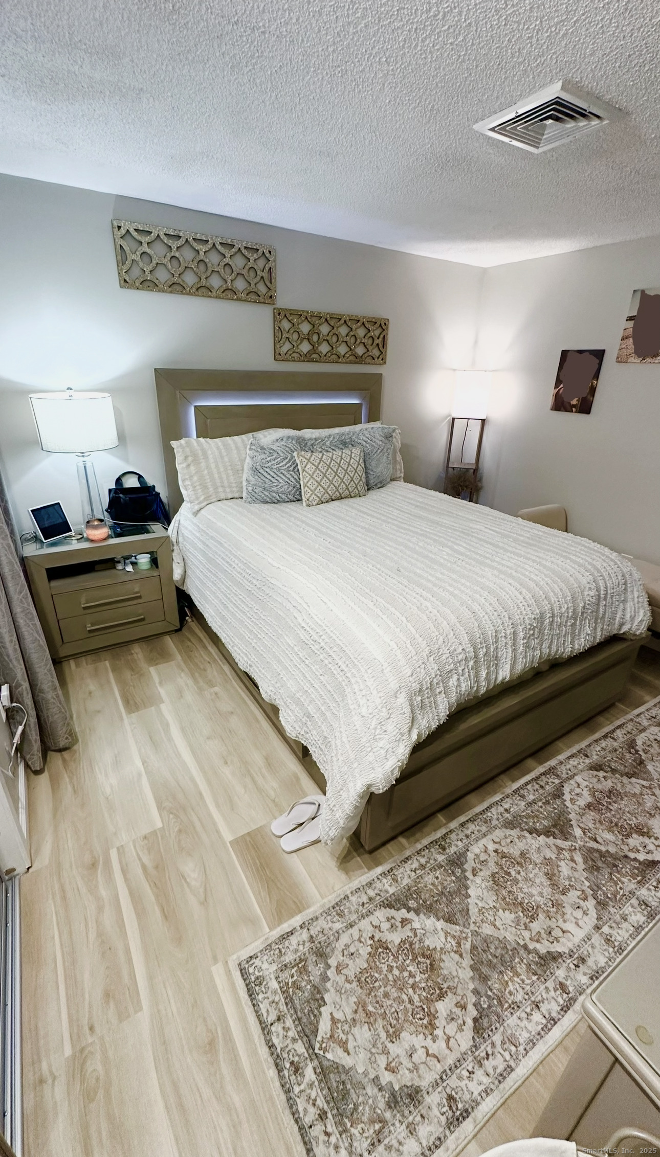 105 Tremont Avenue, Unit B Bridgeport, CT 06606 - Photo 19 of 24 a bedroom with a bed and a mirror