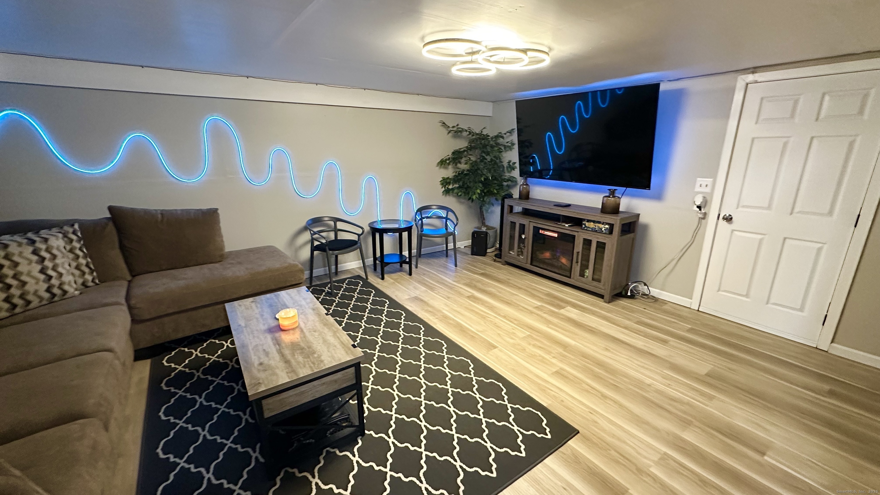 105 Tremont Avenue, Unit B Bridgeport, CT 06606 - Photo 20 of 24 a living room with furniture and a flat screen tv