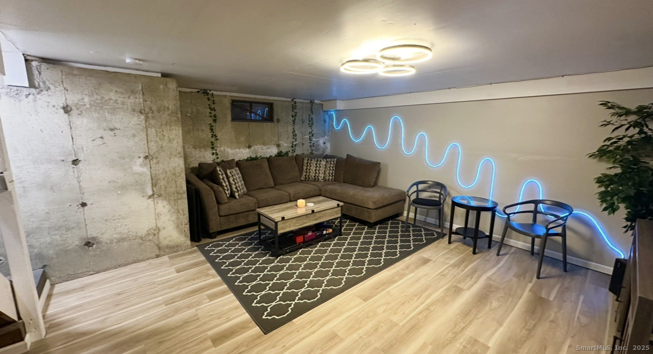 105 Tremont Avenue, Unit B Bridgeport, CT 06606 - Photo 21 of 24 a living room with furniture and a rug