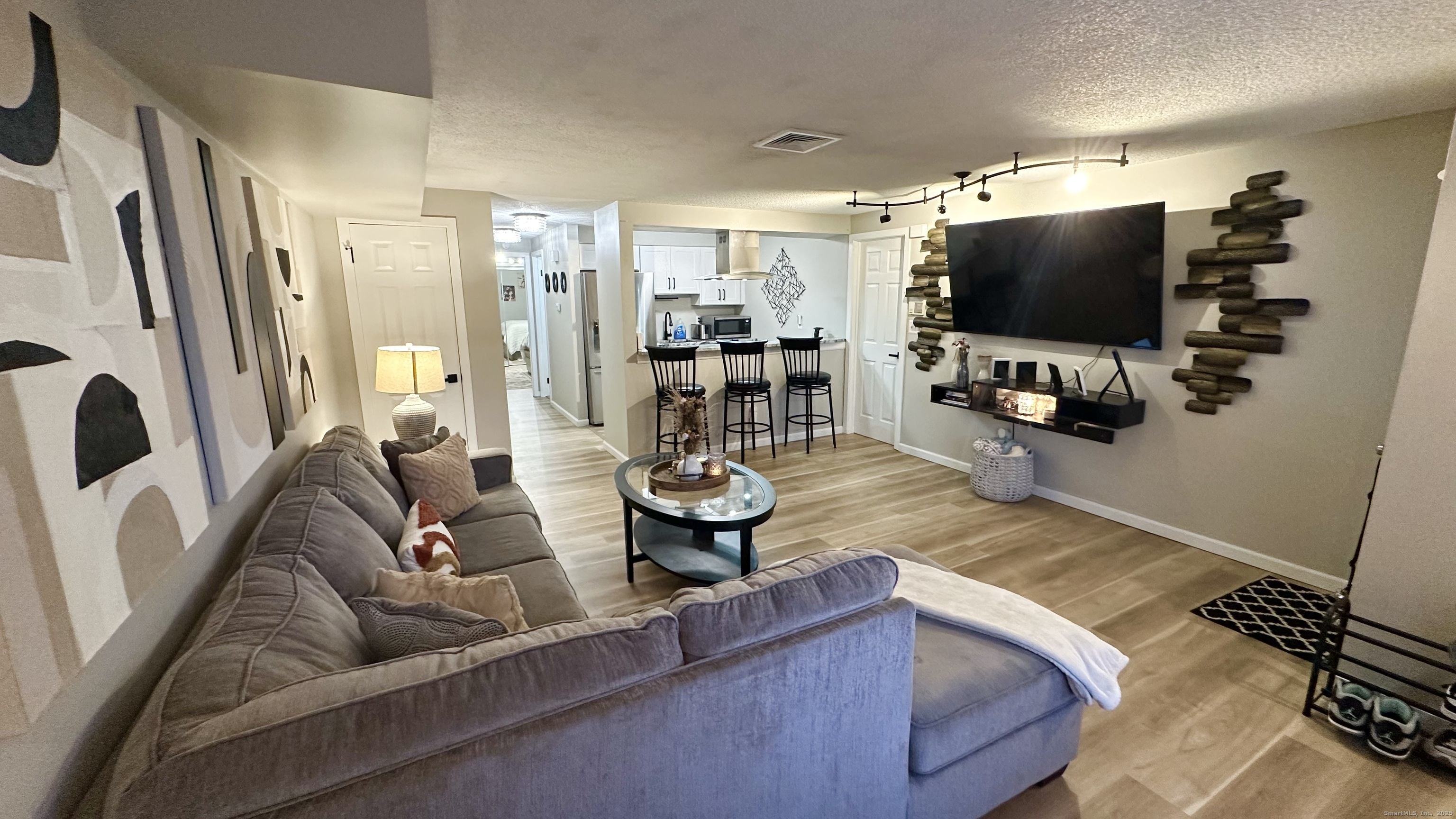 105 Tremont Avenue, Unit B Bridgeport, CT 06606 - Photo 8 of 24 a living room with furniture and a flat screen tv