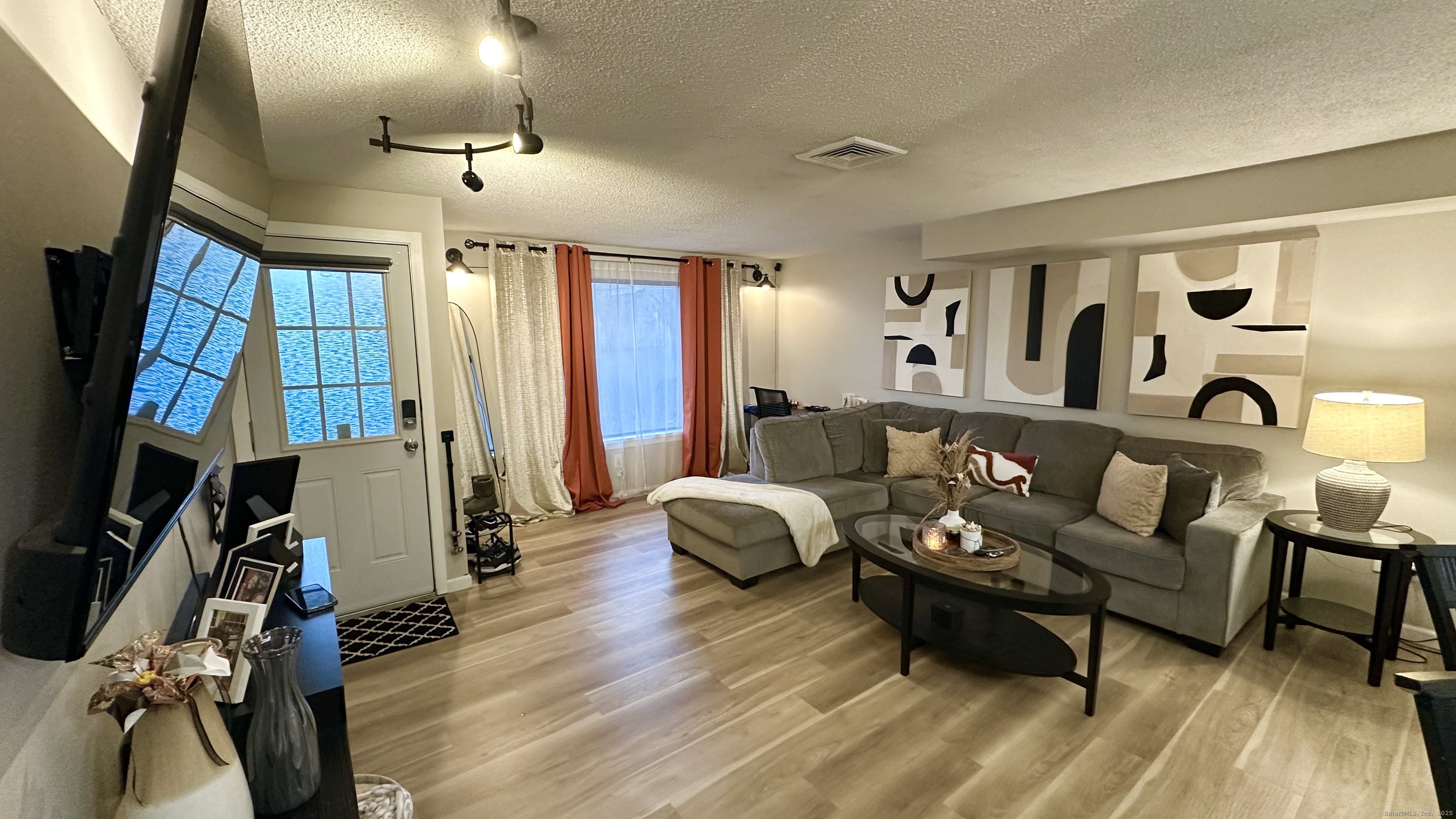 105 Tremont Avenue, Unit B Bridgeport, CT 06606 - Photo 9 of 24 a living room with furniture and a flat screen tv