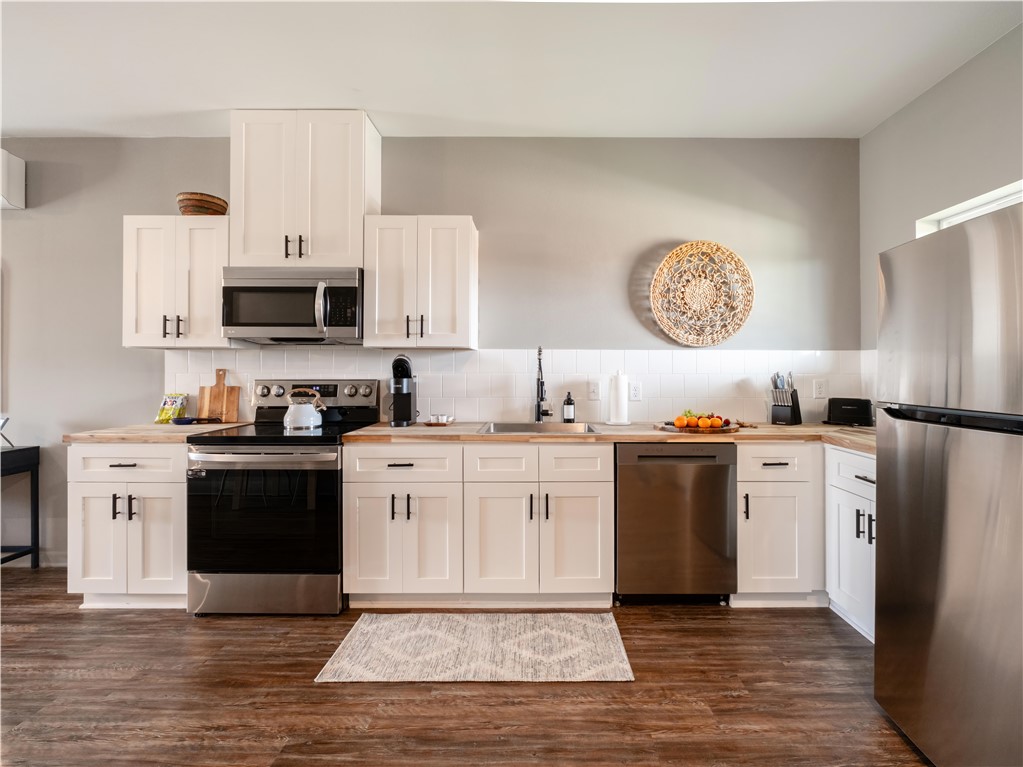 101 West 33rd Street, Unit 103 Bryan, TX 77803 - Photo 3 of 14 a kitchen with a refrigerator stove and sink