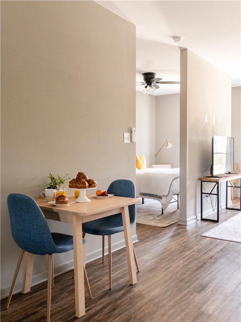 101 West 33rd Street, Unit 103 Bryan, TX 77803 - Photo 5 of 14 a dining room with furniture and wooden floor