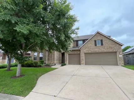a front view of house with yard and trees