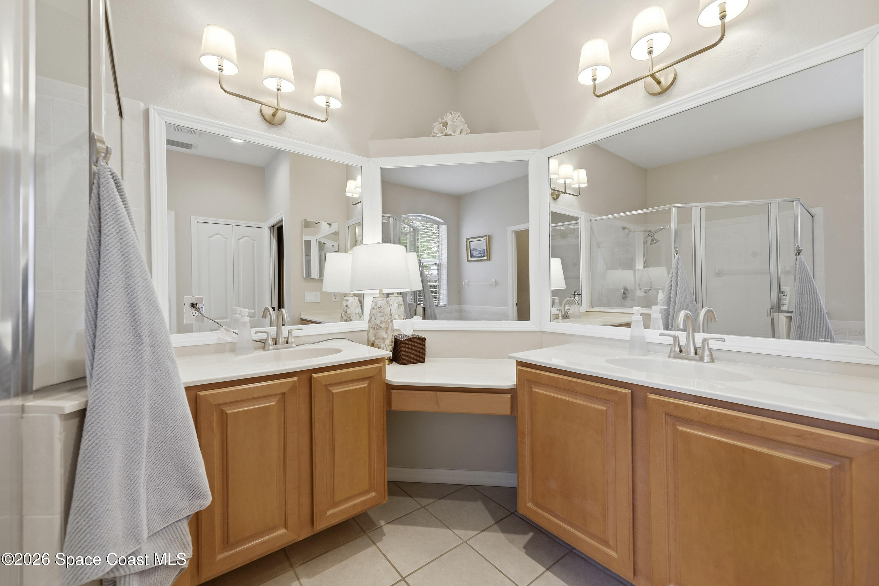 1643 Long Pine Road Melbourne, FL 32940 - Photo 33 of 63 a large bathroom with a double vanity sink a mirror and a bathtub