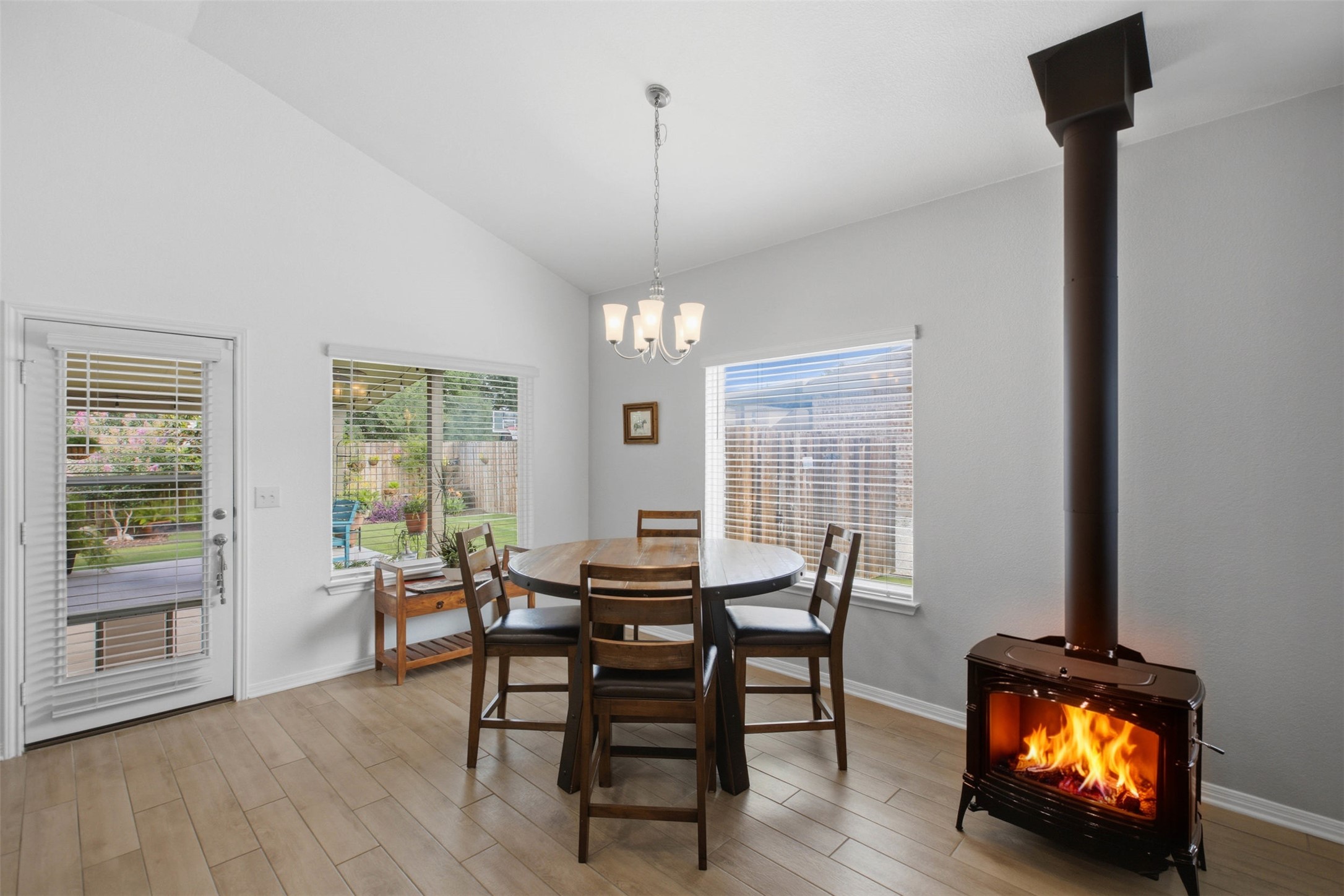 2413 Bridges Ranch Road Georgetown, TX 78628 - Photo 11 of 31 An inviting dining area offers a cozy fireplace and bright outdoor views.
