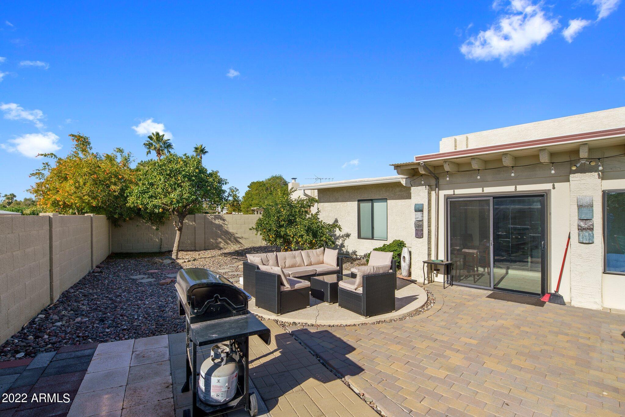 6609 East Phelps Road Scottsdale, AZ 85254 - Photo 74 of 83 a view of a patio with table and chairs and potted plants