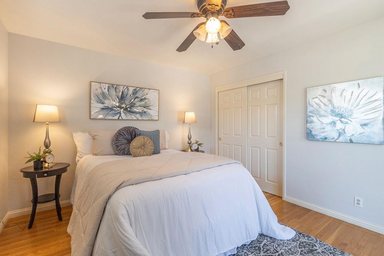 616 Sobrato Drive Campbell, CA 95008 - Photo 17 of 27 a bedroom with a bed and a chandelier