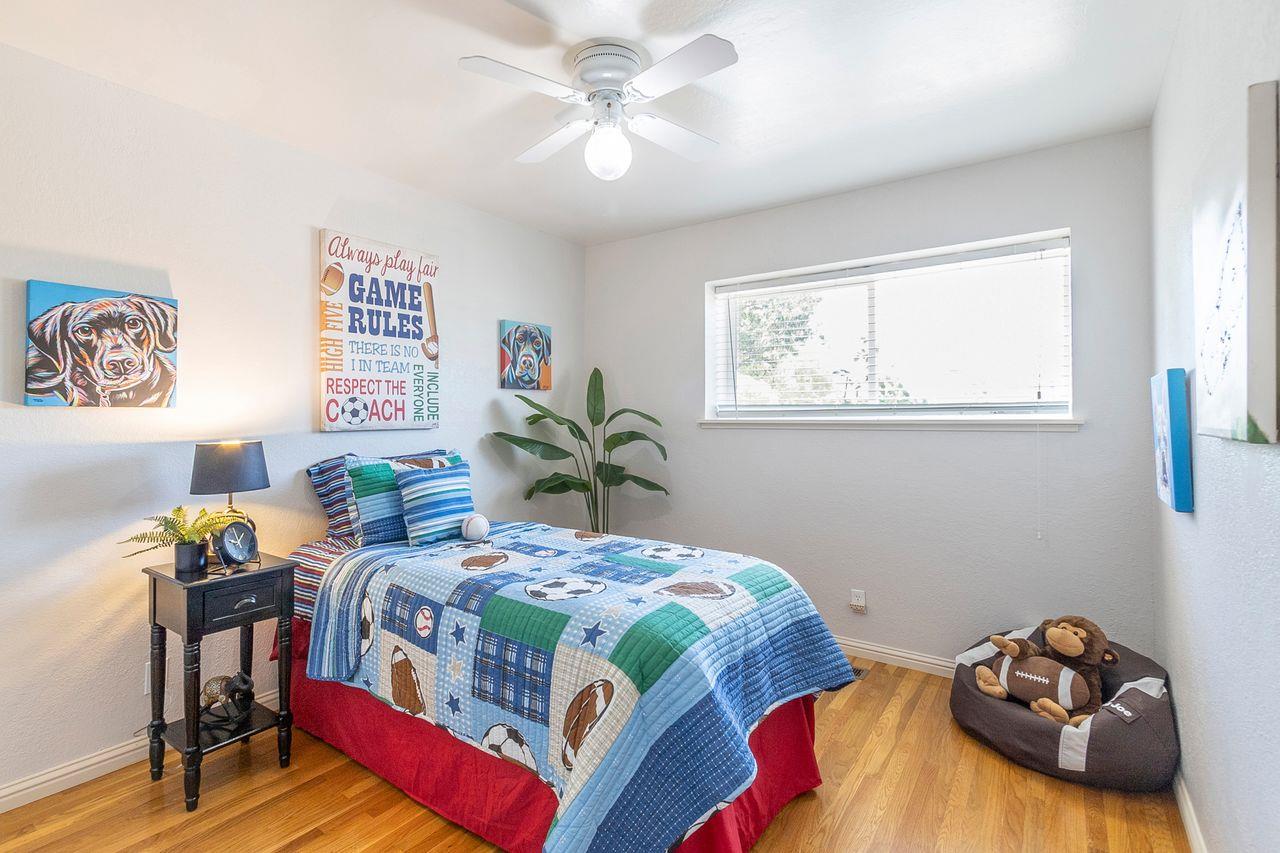 616 Sobrato Drive Campbell, CA 95008 - Photo 22 of 27 a bedroom with a bed and a chandelier