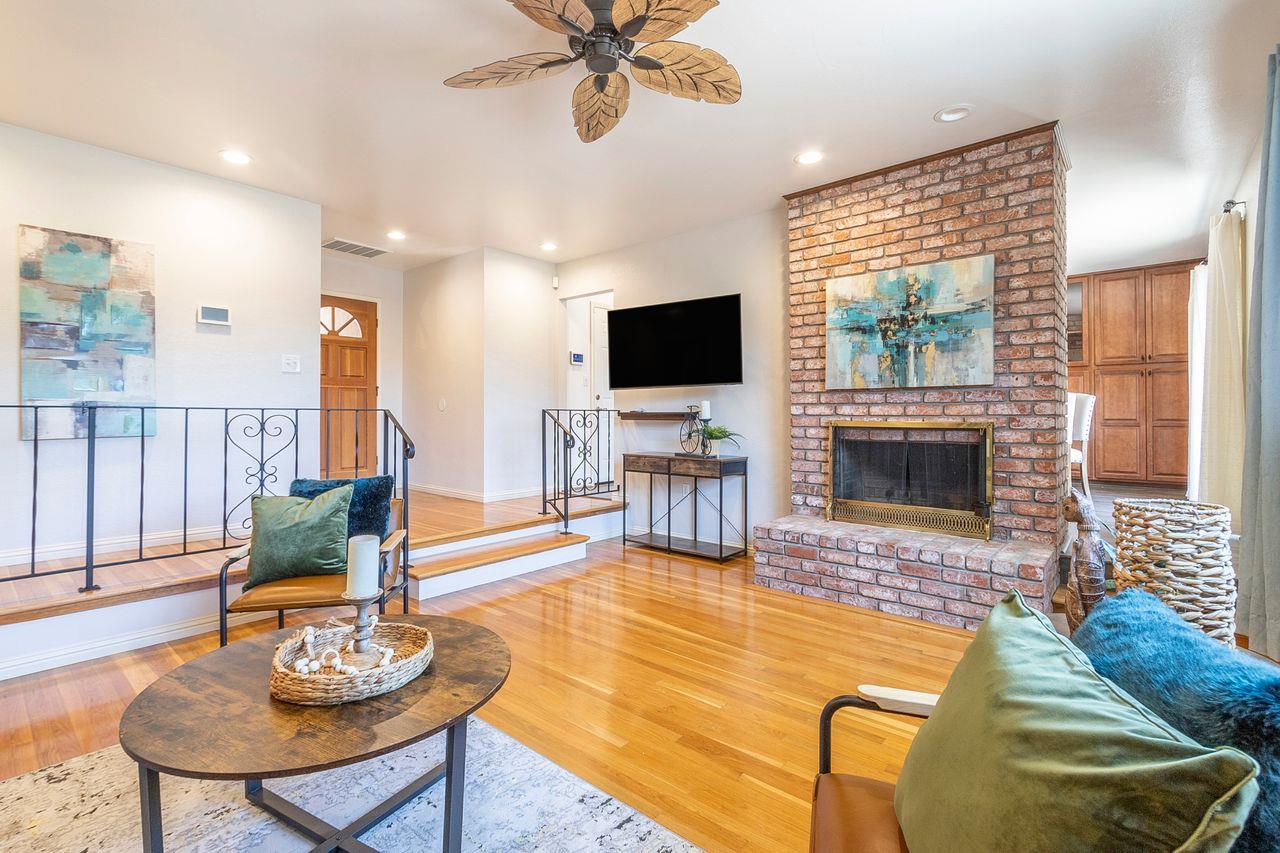 616 Sobrato Drive Campbell, CA 95008 - Photo 9 of 27 a living room with furniture fireplace and a flat screen tv