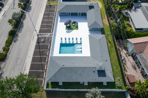 an aerial view of a house with a yard